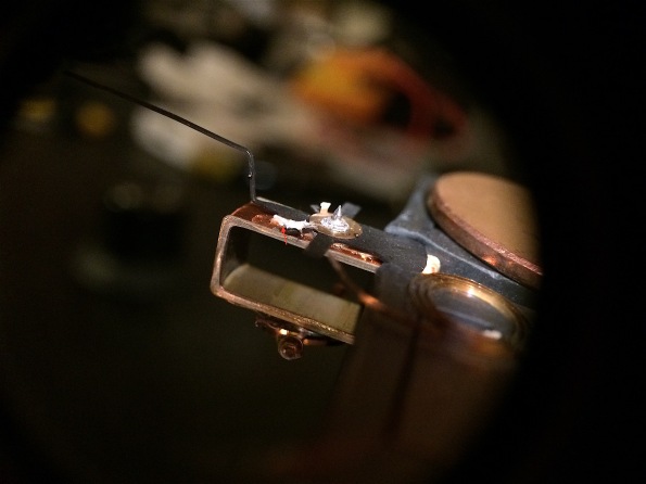 The red arrow points to one of the ends of the coil that attaches to the contact. In my case, both the ends of the coil had to be re-soldered to their contact. It's a painful and slow process, and if like me you don't have a microscope and a good SMD soldering iron, it is very much a difficult and trial-and-error process. You will need time and patience.