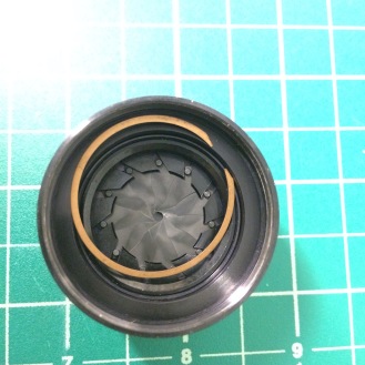 Now you can remove the slotted ring that controls the aperture