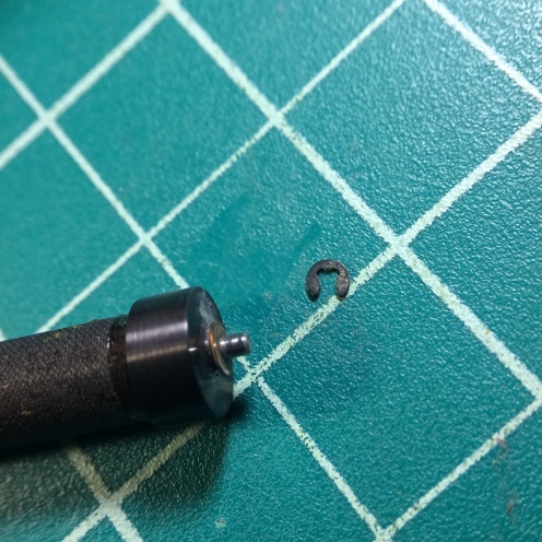 Remove the E-clip at the top of the roller, and remove the brass washer as well