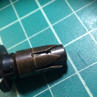 Unscrew this part with a wide slotted screwdriver