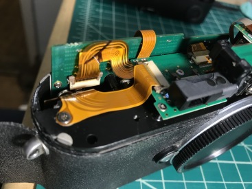 Disconnect the flex cable so that the rear-cover is free to be removed