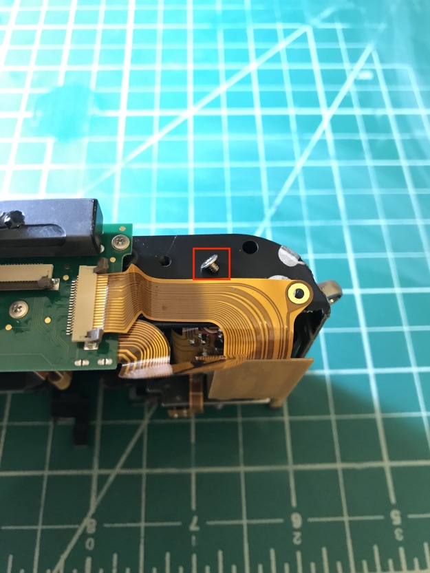 This is roughly where we left off in my previous post about the M8, remove the screw that grounds the flex cable to the front cover/frame.